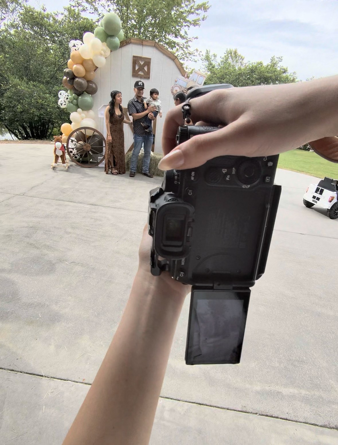 Kayleigh's view through her camera, photographing a family at a first birthday party