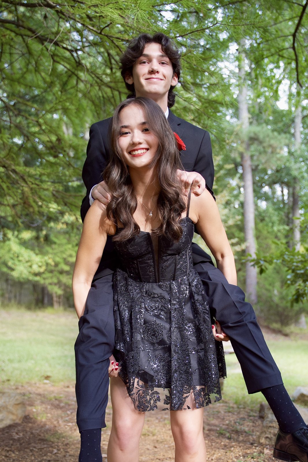A couple posing among the trees