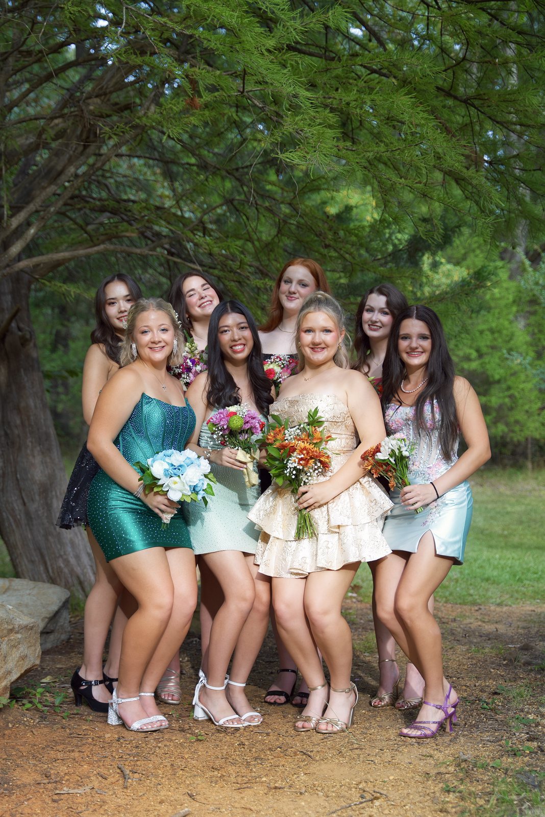A group of friends with their bouquets