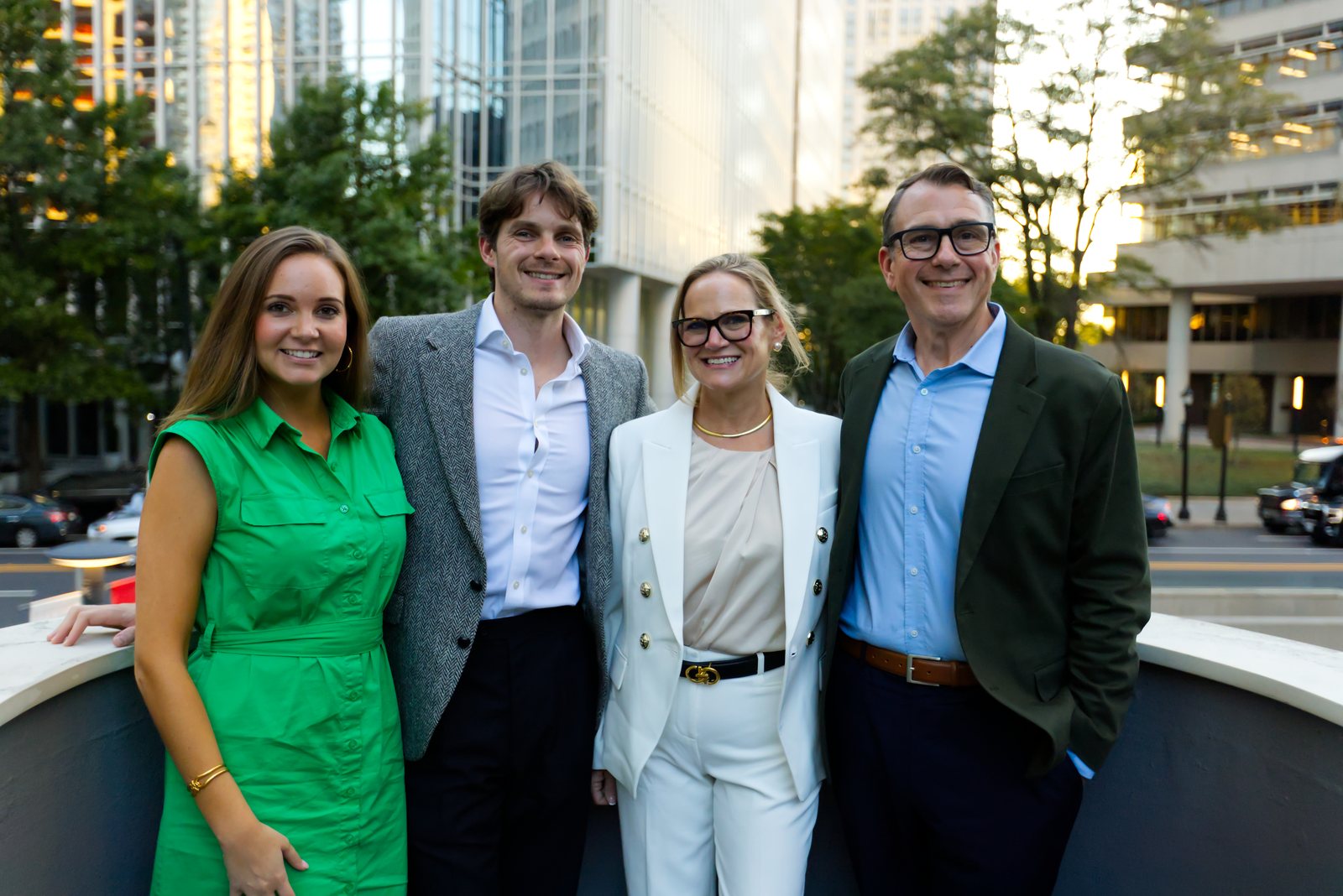 Four guests posing on the rooftop