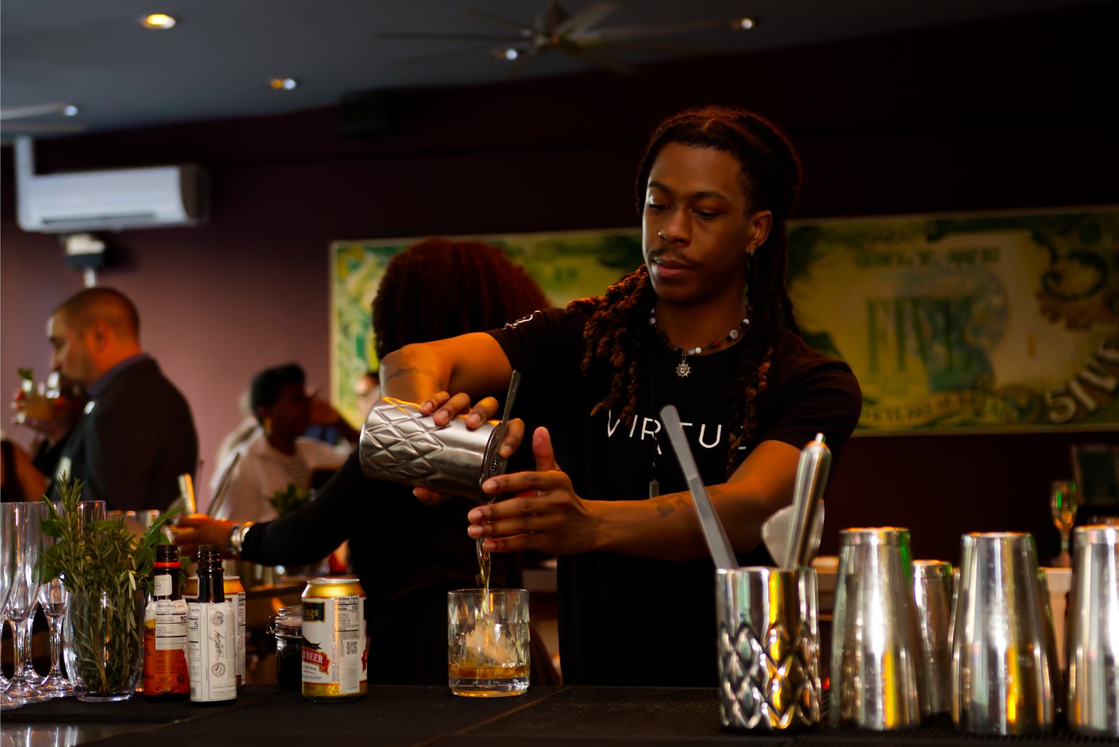 A bartender pouring drinks