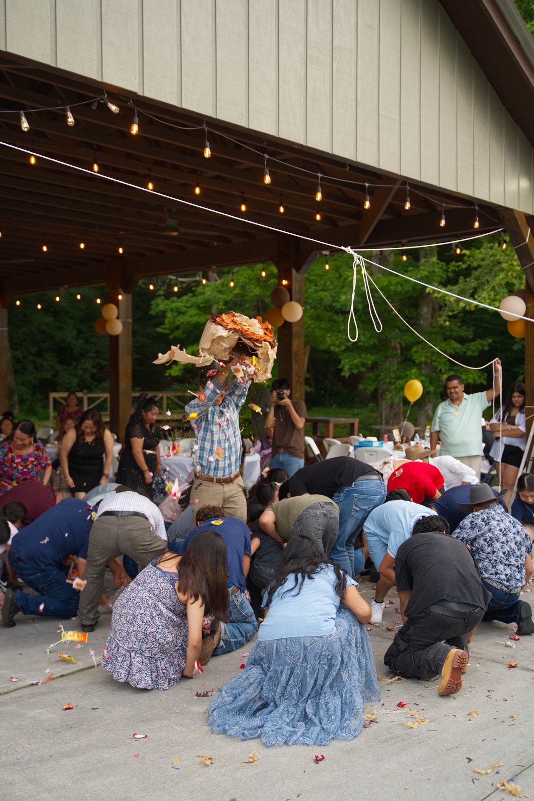 Guests scrambling for candy from the piñata