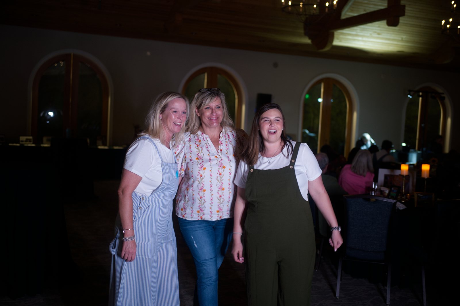 Three guests posing at the gala