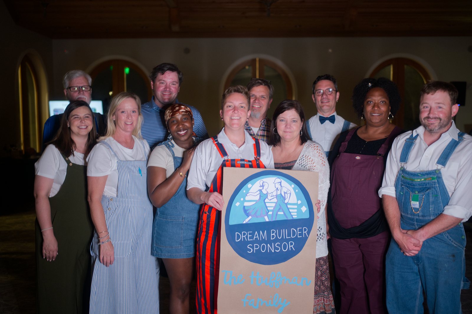 Dream Builder sponsors posing with their sign