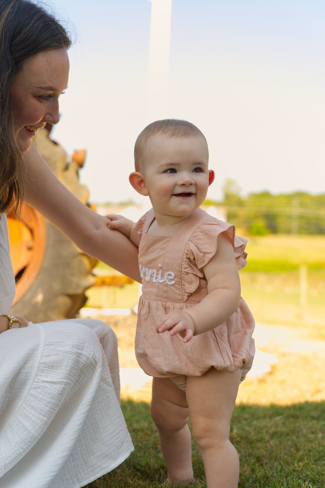 A baby smiling in the golden hour