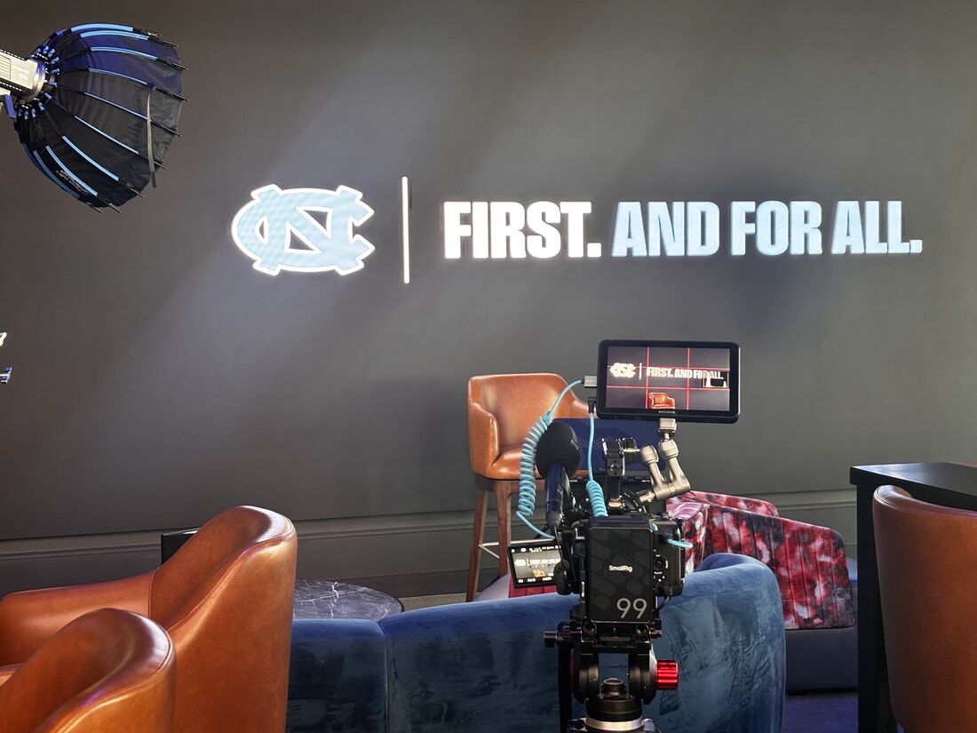 Interview setup for the University of North Carolina at Cosm: a cinema camera and monitor facing two chairs